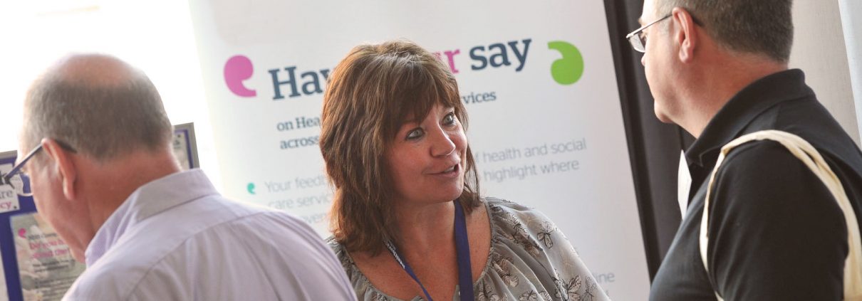 People talking at an information stand