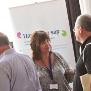 People talking at an information stand