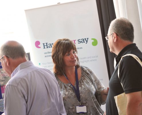 People talking at an information stand