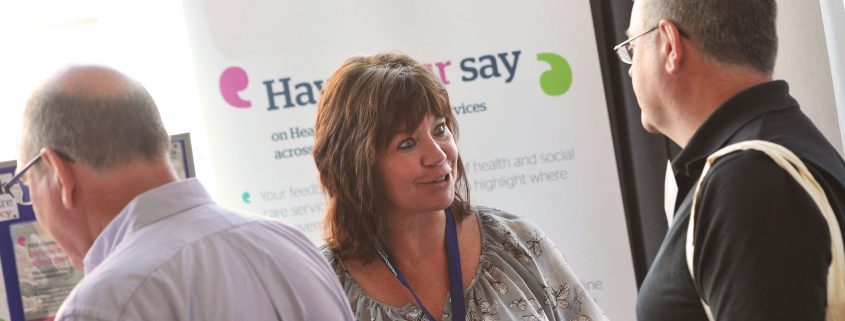 People talking at an information stand