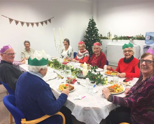 The local group seated about to eat Christmas lunch